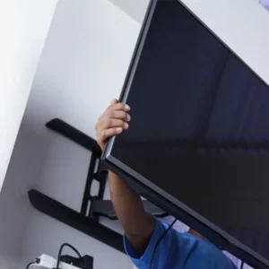 technician mounting flat screen tv on wall