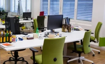 Creative office interior with green chairs and collaborative workspace